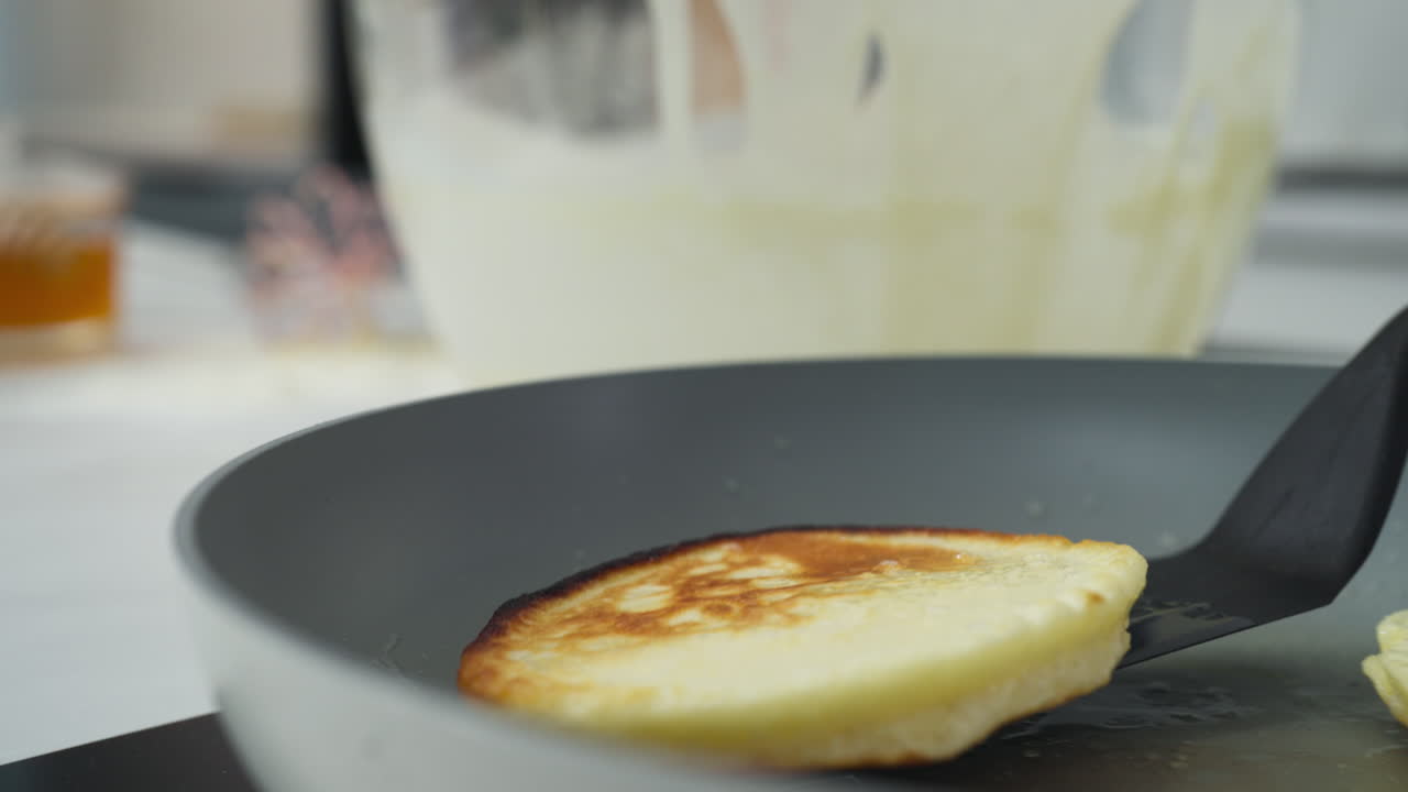 Removing the pancakes from the pan ready to serve. Close up