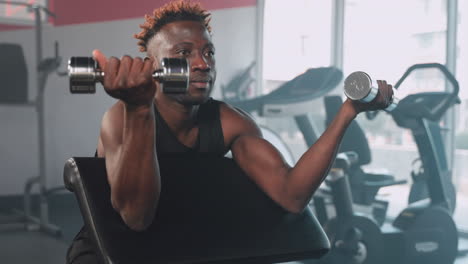 man working out with dumbbells in gym