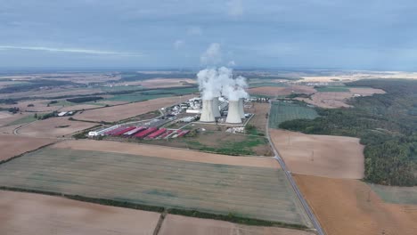 far aerial view of nuclear power plant dukovany cooling towers emit steam