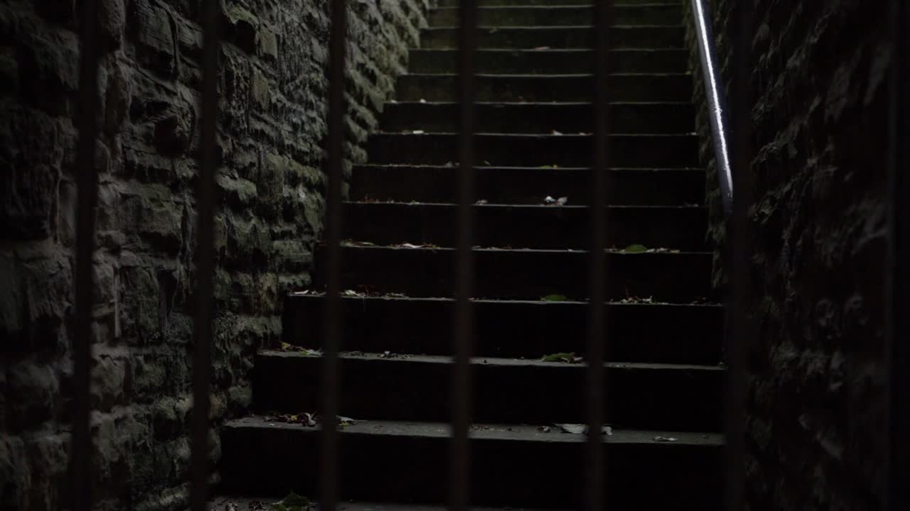 Creepy dark stone stair way medium panning shot