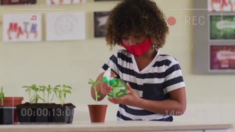 Animation-of-video-recording-interface,-with-child-in-face-mask-watering-plant-at-school