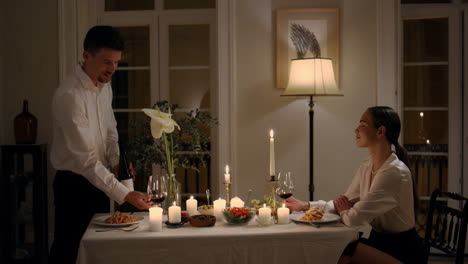 smiling family testing wine at romantic dinner closeup. pair toasting glasses