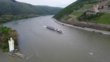 barge hotel cruiser navigating on river rhine by german castles, aerial