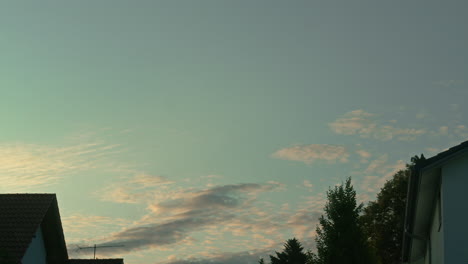 Medium-wide-shot-of-a-sunrise-without-the-sun,-clouds-moving-east