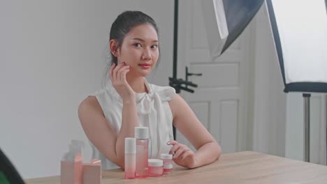 behind the scenes on photo shoot: beautiful asian model poses for a photographer