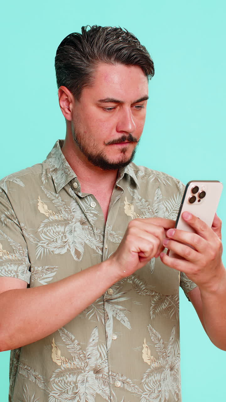 Adult man looking seriously at smartphone reading business news or analytics with focused expression