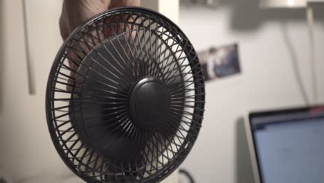 Hand-Turning-Off-The-Portable-Mini-Electric-Fan---Closeup-Shot