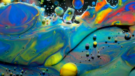 slow motion bright colors bubbles oil beautiful paint universe color moving multicolored closeup. acrylic paint. fantastic surface. abstract colorful paint metamorphosis structure colorful bubbles