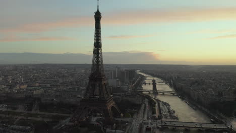 Amazing-aerial-shot-of-famous-steel-structure-on-Seine-river-waterfront.-Eiffel-Tower-and-cityscape-at-dusk.-Paris,-France