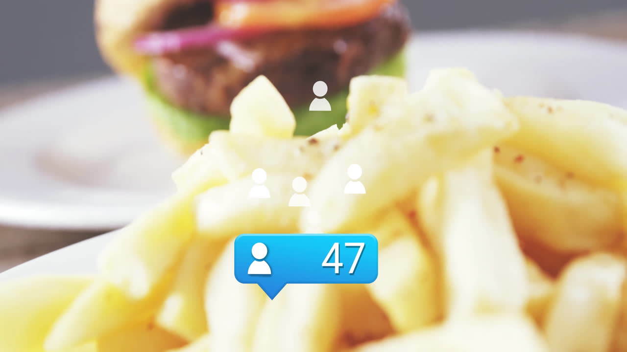 Social media notification animation with French fries, burger blurred in background