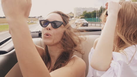 two happy friends enjoying a road trip in a convertible car.