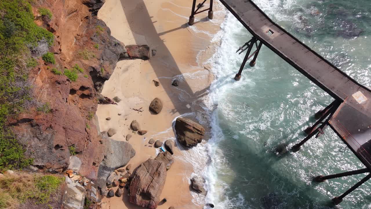 Aerial establishing of jetty and rocks at Catherine Hill Bay beach in New South Wales