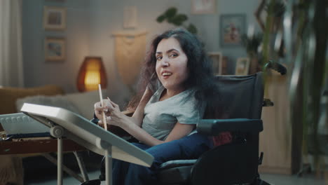 woman in wheelchair painting at home