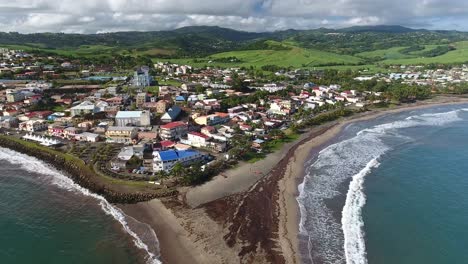 Aerial-drone-shot-zoom-out-on-Sainte-Marie,-natural-tombolo-(island-still-connec