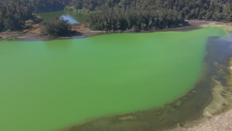 tranquil aerial view of mirror-like emerald green lake