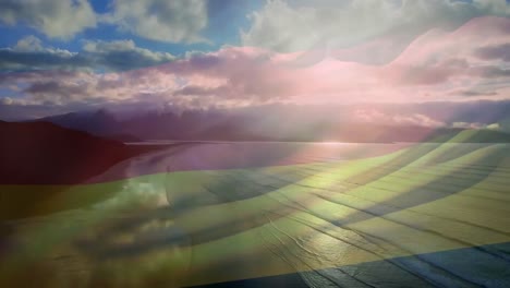 animation of flag of germany waving over beach landscape and cloudy blue sky