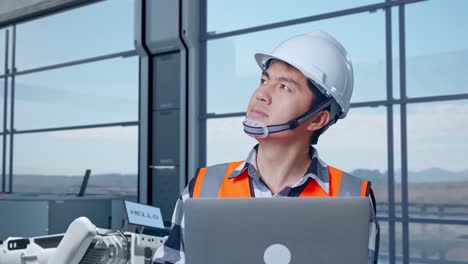 engineer reviewing data in a modern industrial facility