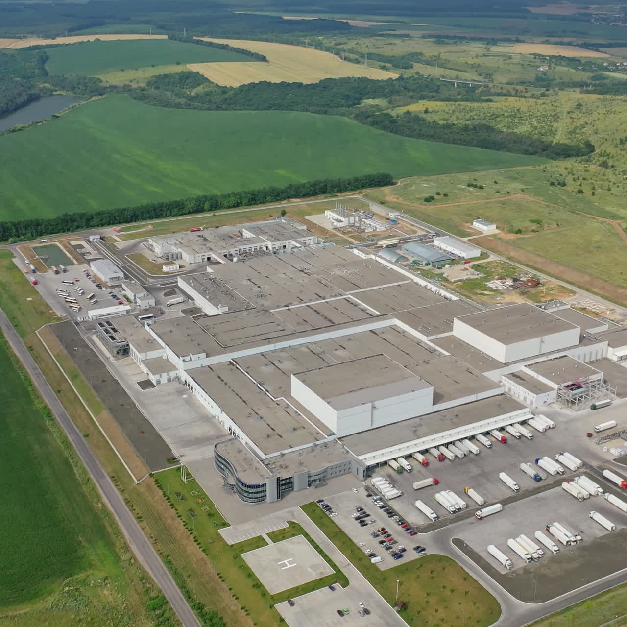 Aerial view of industrial poultry house in field. Manufacturing plant. Industrial territory.