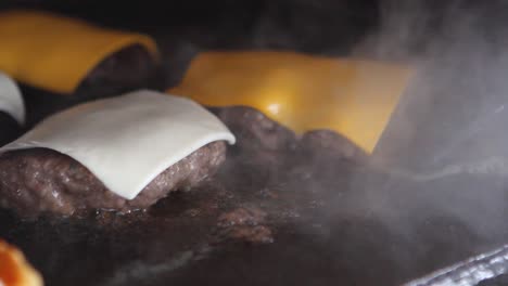 cooking hamburger meat with american and swiss cheese