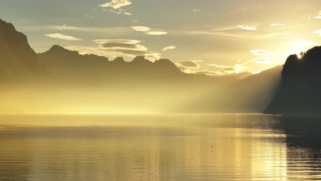 sunset over a calm lake with mountains