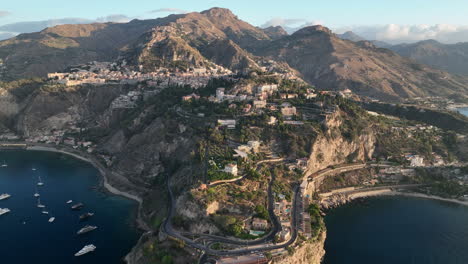sunrise aerial views over the coastal town of taormina, sicily