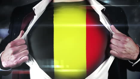 hombre de negocios abriendo la camisa para revelar la bandera de bélgica