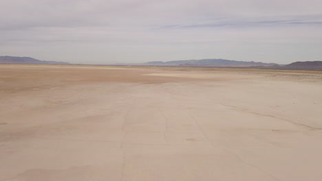 global warming parched earth drought landscape in arizona on a dry lake bed, aerial panning shot