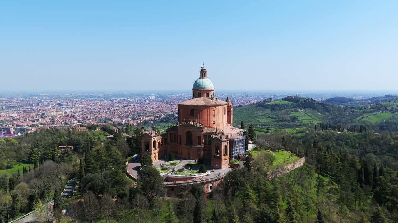 Sanctuary of the Madonna di San Luca Perched On Hilltop, Overlooking City Of Bologna In Italy. pullback drone shot