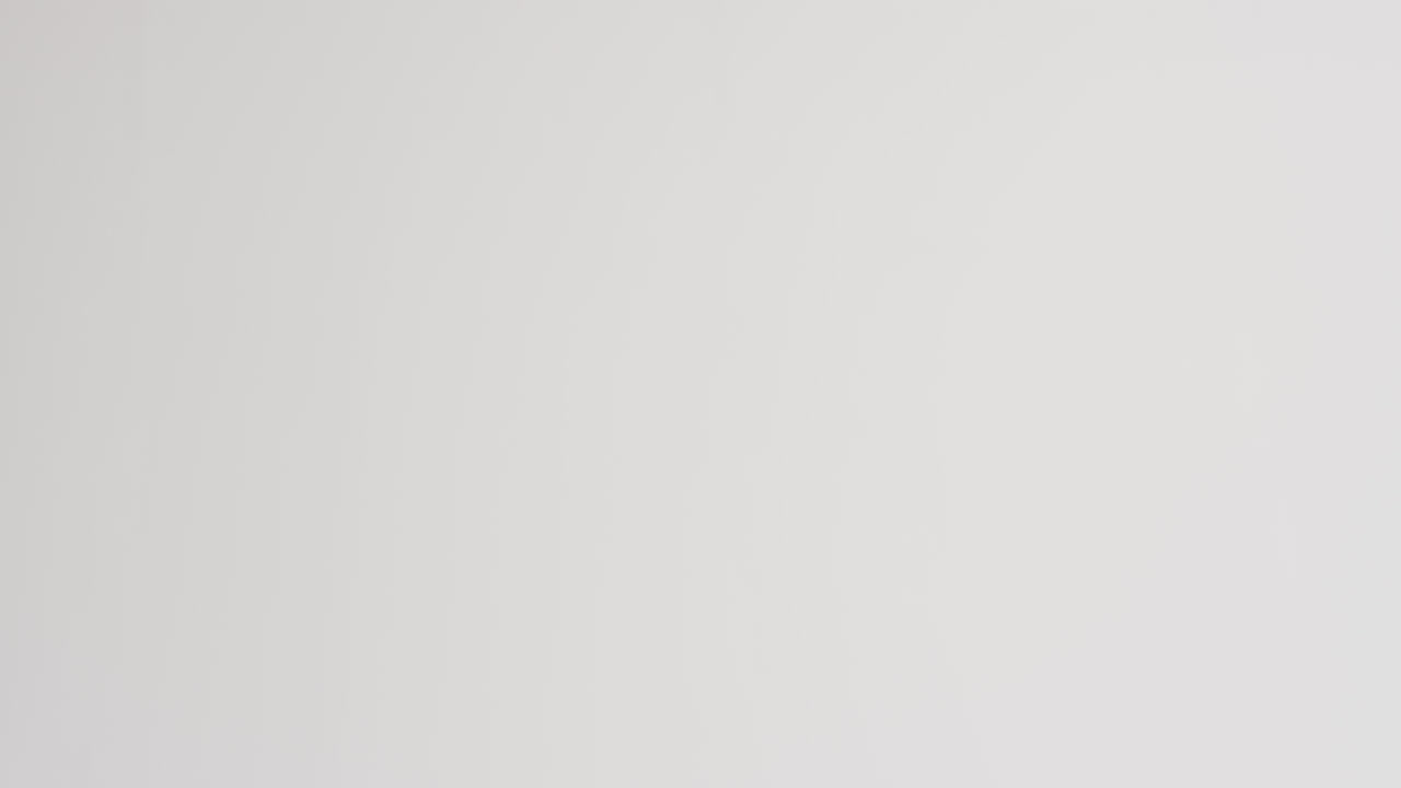 White rugby ball on white background with copy space, slow motion