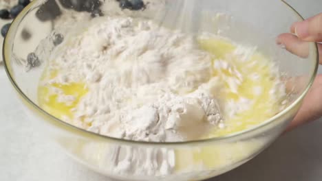 baking ingredients being whisked in a glass bowl, cooking preparation