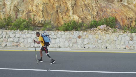 sporty mixed race man with prosthetic leg hiking