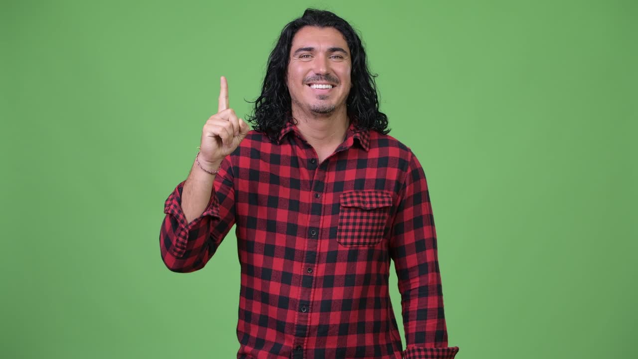 Handsome hipster man pointing finger up