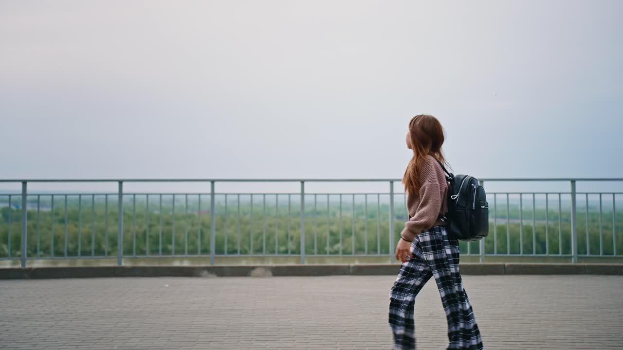 Teenage Girl Walking on a Bridge