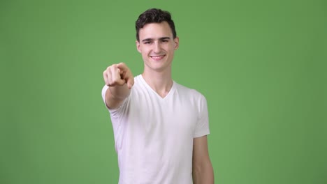 young happy handsome man pointing at camera