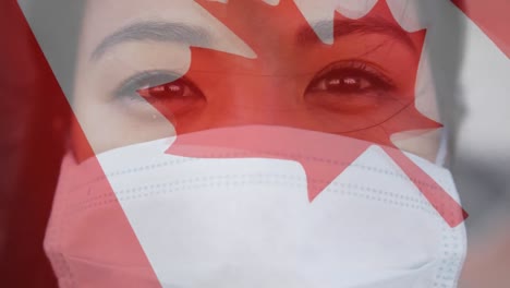 Canadian-flag-waving-against-woman-wearing-face-mask