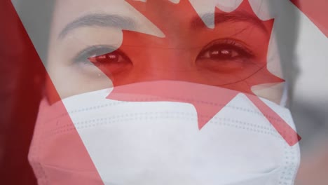 bandera canadiense ondeando contra una mujer que lleva una máscara facial