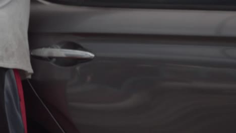 slow motion video while drying the freshly washed black car.