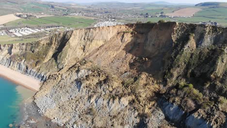 aerial over massive cliff fall debris into english channel at seatown in dorset