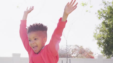 Happy-african-american-boy-laying-playing-and-smiling-in-garden