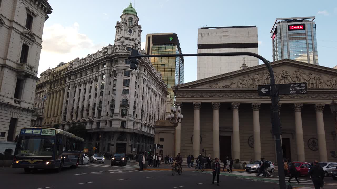 People cross de Mayo Avenue Buenos Aires Cathedral landmark panoramic touristic spot in winter, heritage buildings background