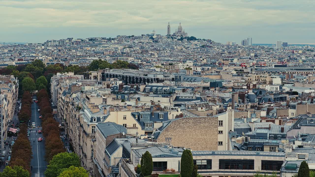 Aerial view of Sacre Couer Cathedral high above the rooftops of Paris, France. Static handheld wide shot