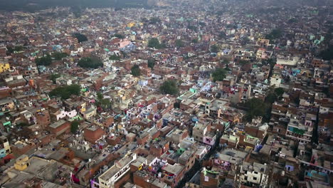 India-city-living-Arga-near-iconic-Taj-Mahal-Rural-city-scape-smog-pollution-India-view-of-busy-streets-with-tuk-tucks,-bikes,-cars-and-ricksaws-aerial-motion-forward