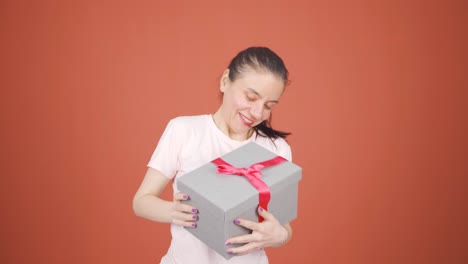 happy and joyful woman opening gift package.