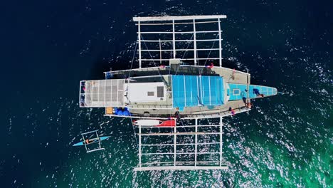 top-down drone footage of a typical filipino boat with people