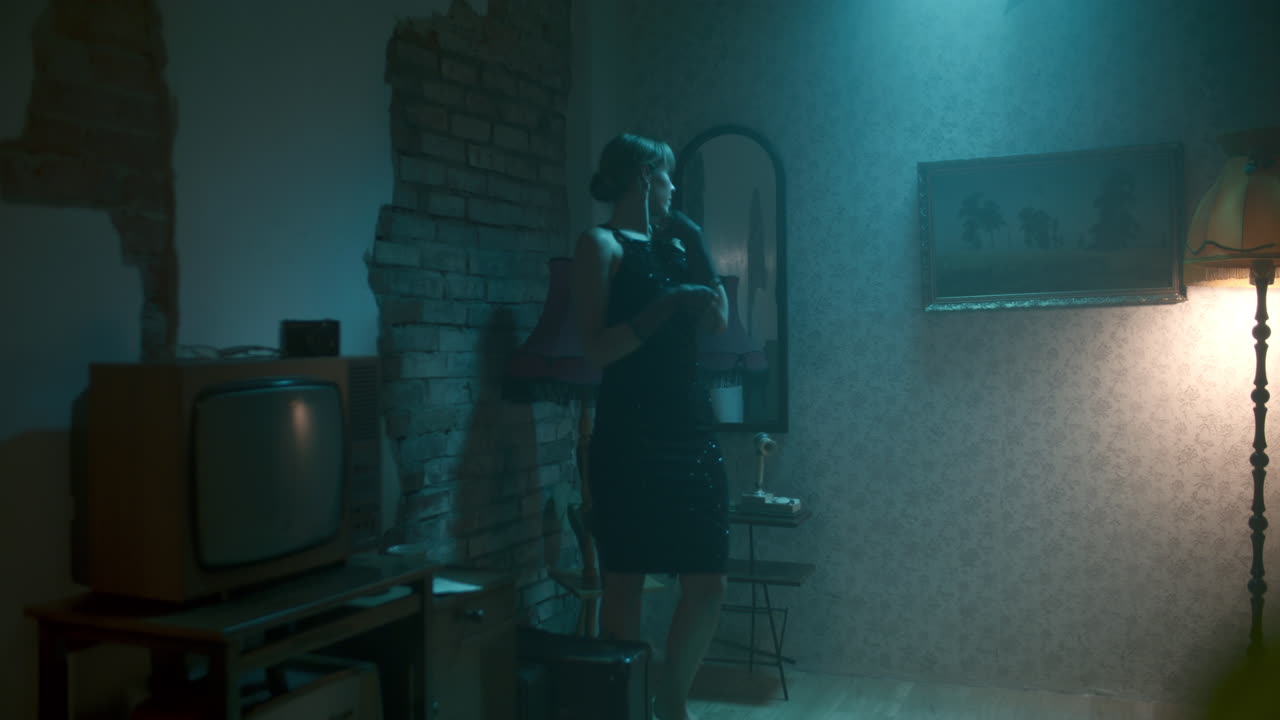 Woman in a vintage dress in a retro room at night