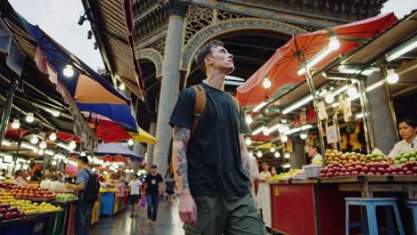 man exploring a vibrant asian market