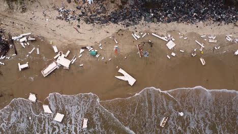 plastical and metal debris are scattered along the coastline of malibu beach in vietnam