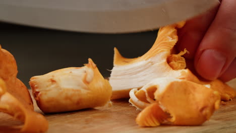 chopping orange mushrooms