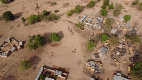 Drone-flies-over-village-in-Burkina-Faso,-Africa