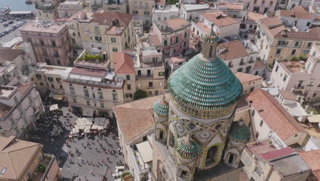 footage rotating around the top bell tower of a church in amalfi, italy